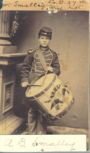 Young boy in military uniform with drum
