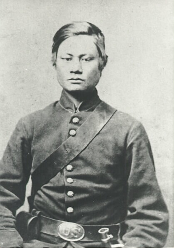 Image of man sitting down in military uniform